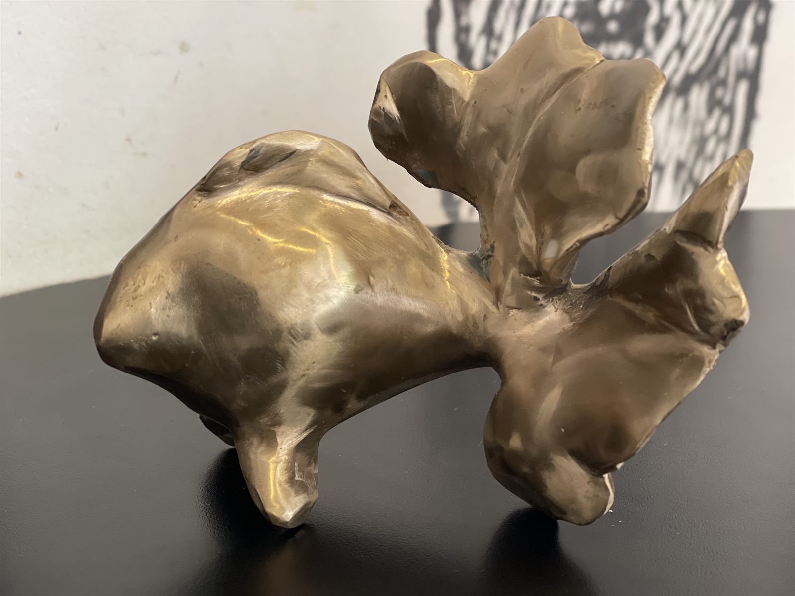 Goldfish — a small bronze sculpture of a goldfish with flowing fins, on a dark surface
