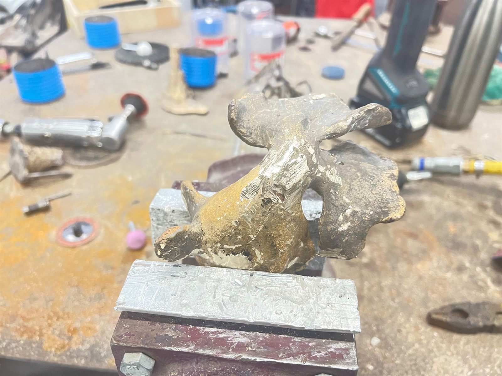 Goldfish — the bronze casting on the bench with the sprues being cut away