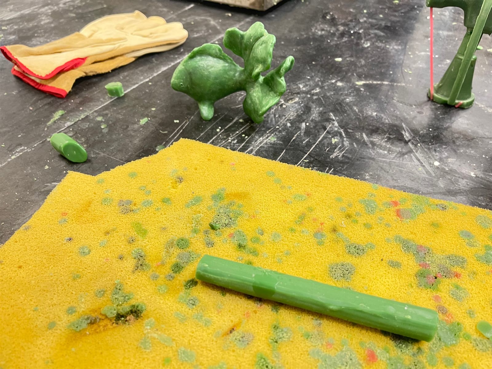 Goldfish — the wax model on the workbench with wax rod and tools