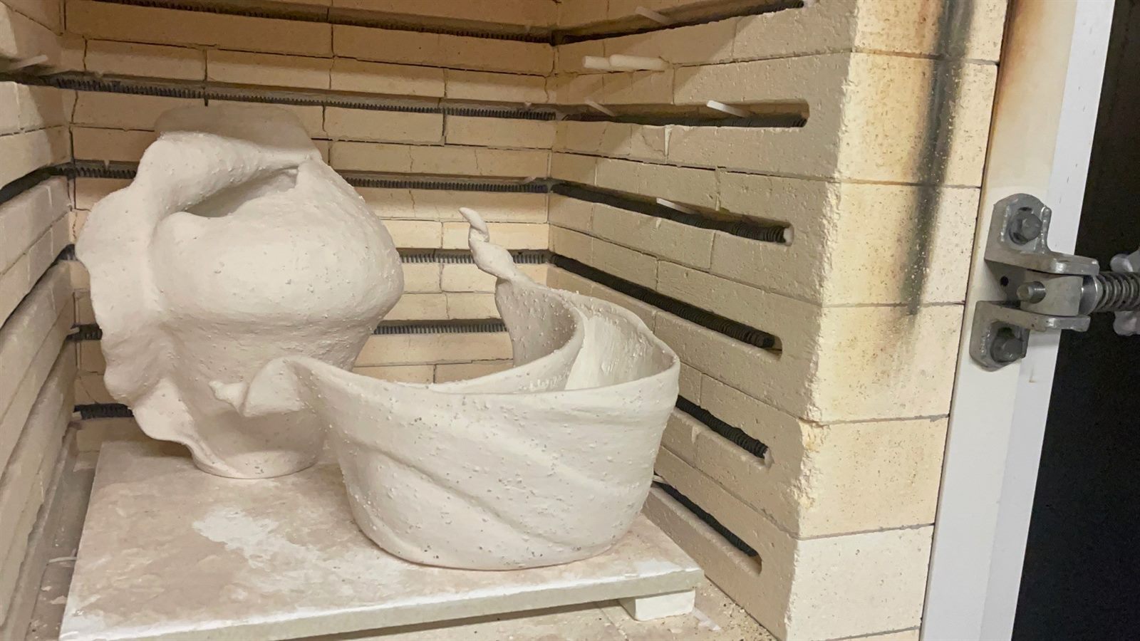 Holding Memory — both vessels loaded in the kiln before firing