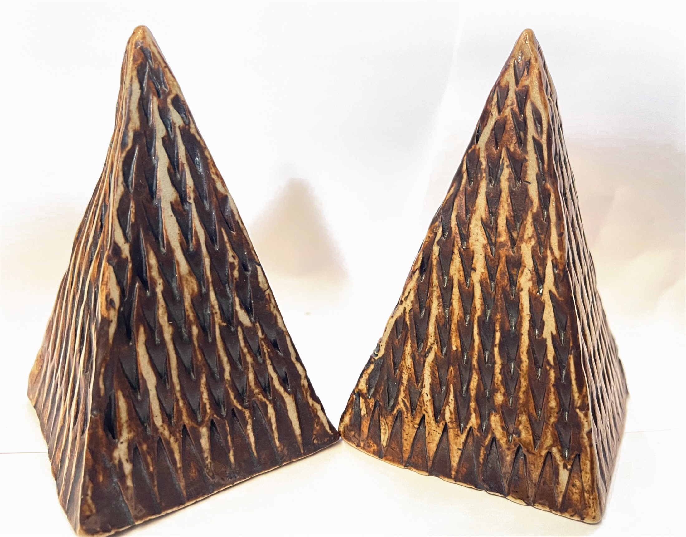 Kilim — both carved ceramic pyramids standing side by side
