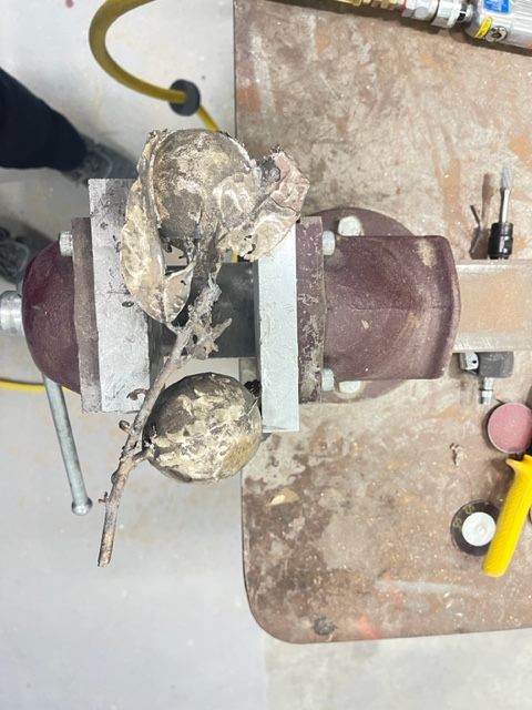 Lemon Branch — the raw bronze casting clamped in a vice, still covered in investment