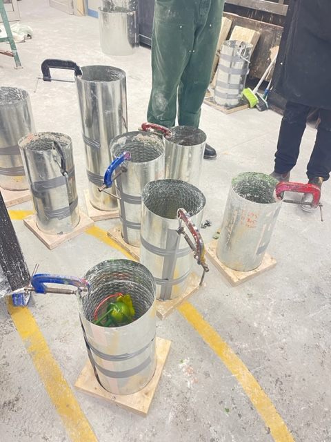 Casting flasks prepared and lined up on the foundry floor