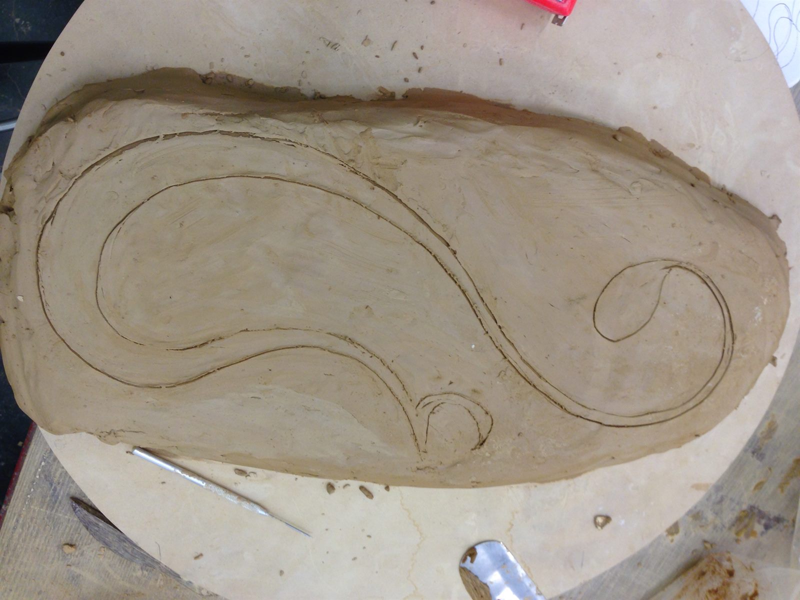 LOVE — calligraphy carved into a clay slab