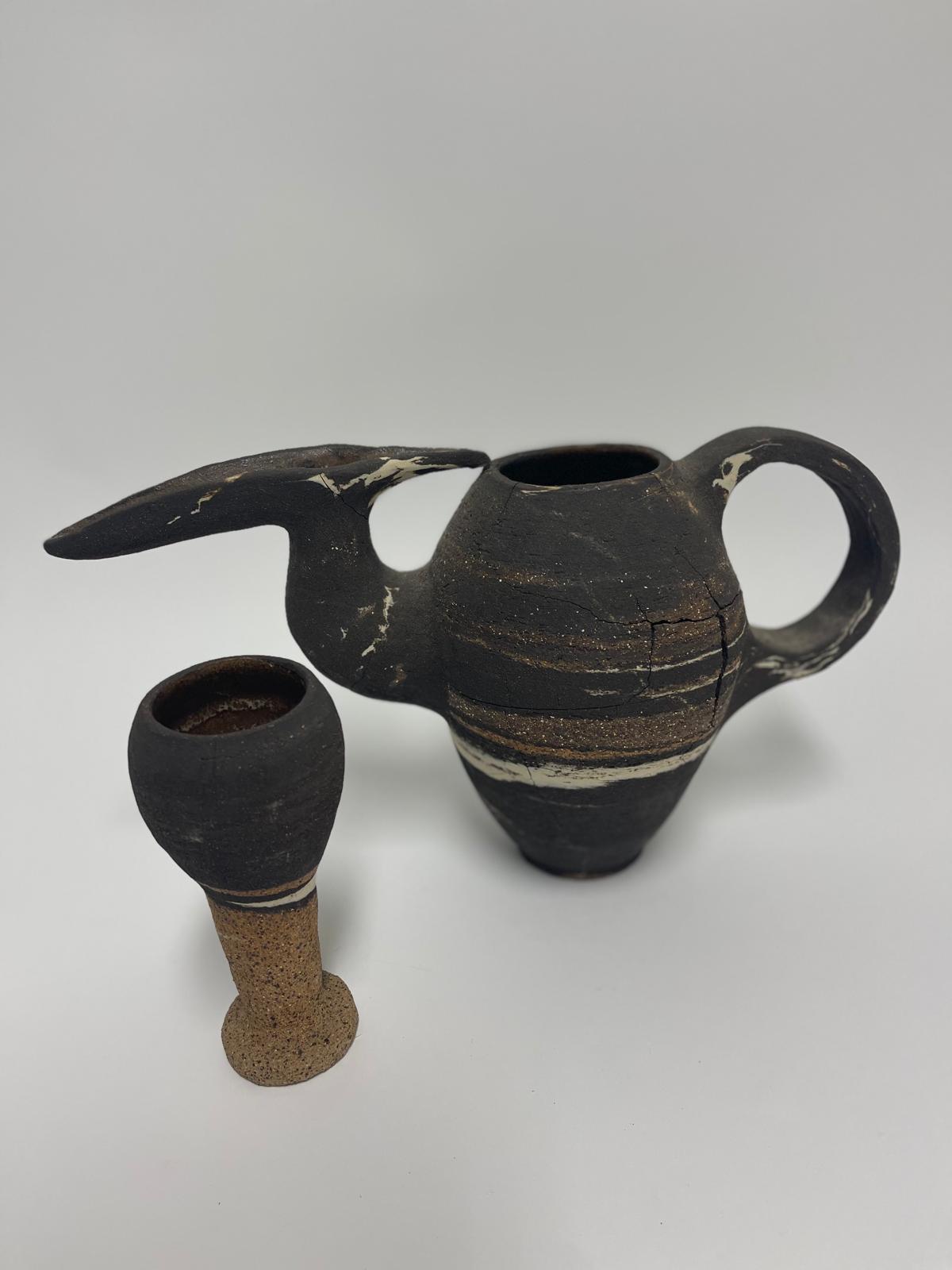 Marlik Vessels — closer view of the long-spouted marbled vessel and the small goblet