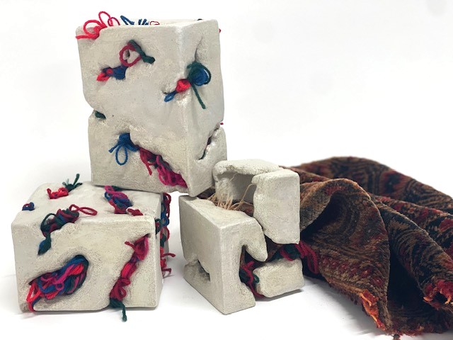 Threads of Home, installation with Persian rug, wool and clay